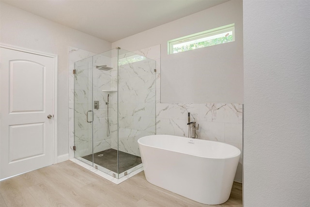 507 S 4th St, Grandview, TX 76050 - bathroom with wood finished floors, a freestanding tub, and a marble finish shower