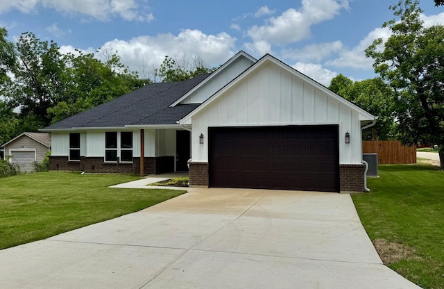 507 S 4th St, Grandview, TX 76050 - view of front of home featuring board and batten siding, an attached garage, brick siding, and concrete driveway