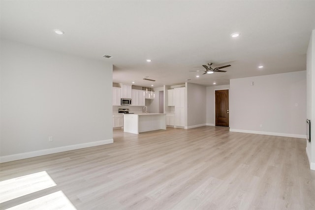 507 S 4th St, Grandview, TX 76050 - unfurnished living room featuring recessed lighting, a ceiling fan, and light wood finished floors
