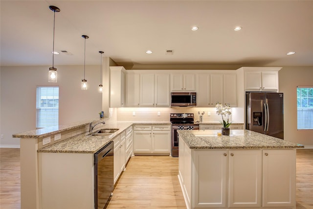 109 W Damon St, Terrell, TX 75160 - kitchen with stainless steel appliances, light wood finished floors, backsplash, light stone countertops, and a kitchen island