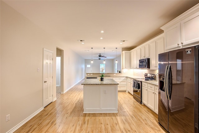 109 W Damon St, Terrell, TX 75160 - kitchen featuring black refrigerator with ice dispenser, stainless steel range with electric cooktop, a peninsula, a ceiling fan, and white cabinets