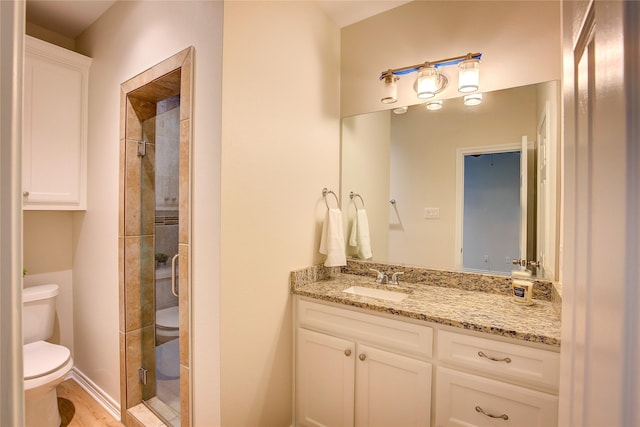 109 W Damon St, Terrell, TX 75160 - bathroom with vanity, a shower stall, and wood finished floors