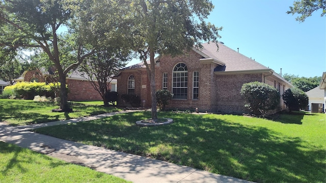 11521 Blanchard Dr, Frisco, TX 75035 - view of front of house with brick siding, a front yard, and a shingled roof