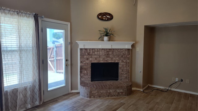 11521 Blanchard Dr, Frisco, TX 75035 - unfurnished living room featuring wood finished floors and a brick fireplace