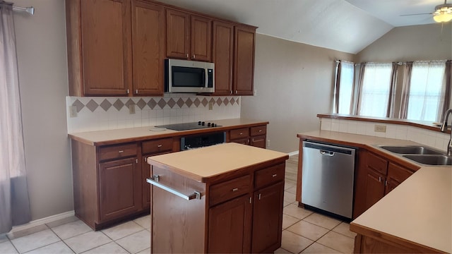 11521 Blanchard Dr, Frisco, TX 75035 - kitchen featuring appliances with stainless steel finishes, light tile patterned flooring, decorative backsplash, a ceiling fan, and lofted ceiling