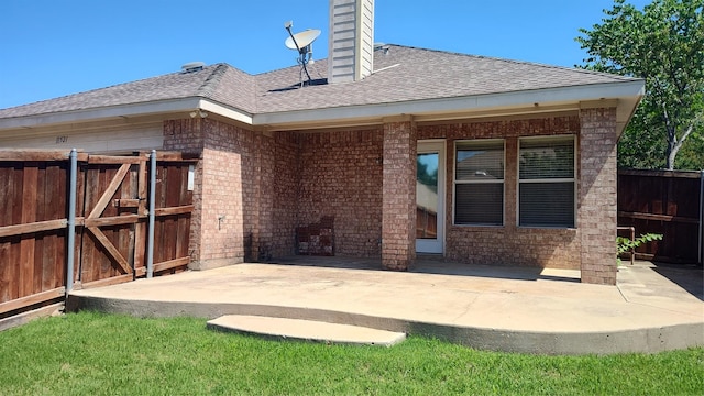 11521 Blanchard Dr, Frisco, TX 75035 - back of house featuring brick siding, a chimney, a patio area, and a shingled roof