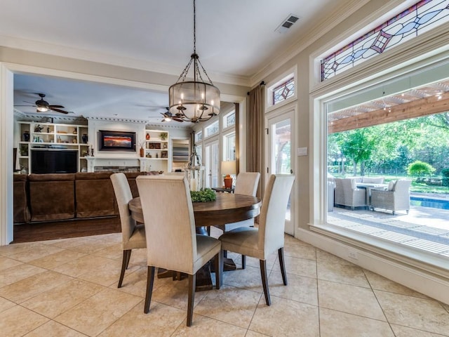 1908 Peninsula Dr, Flower Mound, TX 75022 - dining room featuring light tile patterned flooring, crown molding, a chandelier, and a ceiling fan