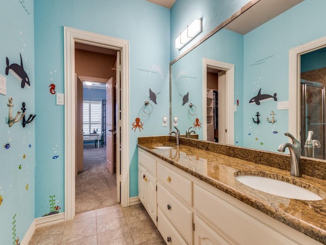 1908 Peninsula Dr, Flower Mound, TX 75022 - bathroom with double vanity, a shower with door, tile patterned flooring, and a spacious closet