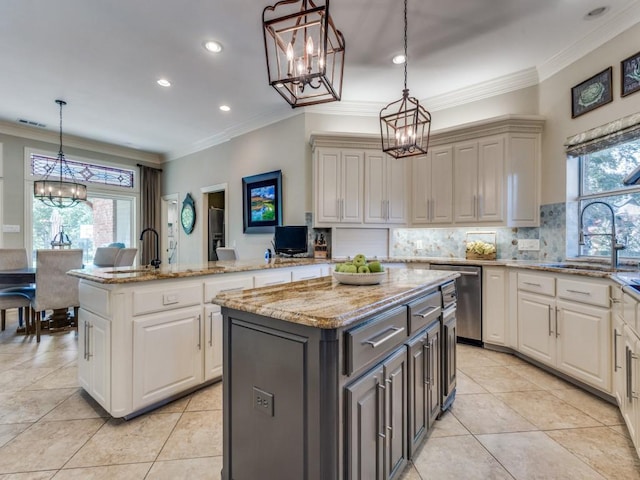 1908 Peninsula Dr, Flower Mound, TX 75022 - kitchen featuring a chandelier, stainless steel dishwasher, a kitchen island, light tile patterned flooring, and ornamental molding