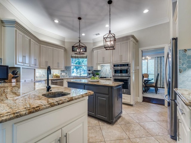 1908 Peninsula Dr, Flower Mound, TX 75022 - kitchen featuring gray cabinetry, stainless steel appliances, plenty of natural light, recessed lighting, and ornamental molding