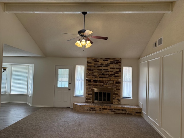 928 Rosebud Dr, Azle, TX 76020 - unfurnished living room featuring a ceiling fan, dark colored carpet, a fireplace, beamed ceiling, and high vaulted ceiling