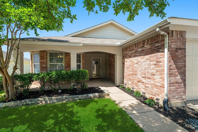 1722 Chestnut St, Anna, TX 75409 - view of exterior entry with a garage, brick siding, and a yard