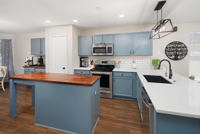1722 Chestnut St, Anna, TX 75409 - kitchen with stainless steel appliances, butcher block counters, dark wood-type flooring, blue cabinets, and recessed lighting
