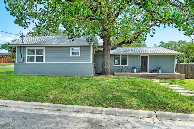 411 Harcourt St, Weatherford, TX 76086 - view of front of house featuring brick siding, a metal roof, and covered porch