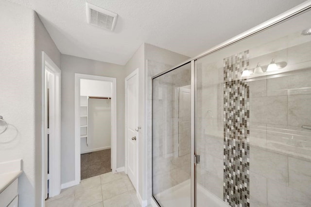 120 Big Bend Dr, Forney, TX 75126 - full bath with vanity, a shower stall, a spacious closet, and tile patterned floors