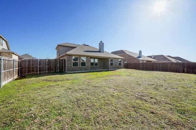 120 Big Bend Dr, Forney, TX 75126 - back of property with brick siding, a chimney, and a fenced backyard