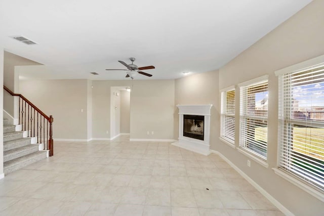 120 Big Bend Dr, Forney, TX 75126 - unfurnished living room with a ceiling fan, a glass covered fireplace, and stairs