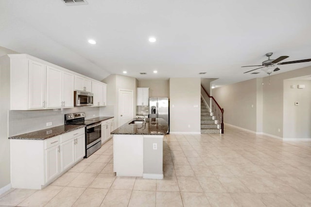 120 Big Bend Dr, Forney, TX 75126 - kitchen featuring stainless steel appliances, backsplash, ceiling fan, dark stone countertops, and white cabinets