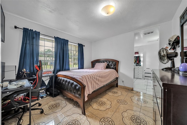 6354 Cinnamon Oaks, Dallas, TX 75241 - bedroom featuring light tile patterned floors and a textured ceiling