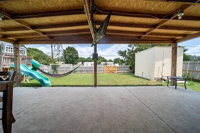 6354 Cinnamon Oaks, Dallas, TX 75241 - view of patio / terrace with a storage unit and a playground