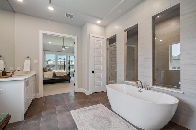 233 Kirkpatrick Ct, Argyle, TX 76226 - bathroom featuring a soaking tub, vanity, a ceiling fan, recessed lighting, and tile patterned flooring