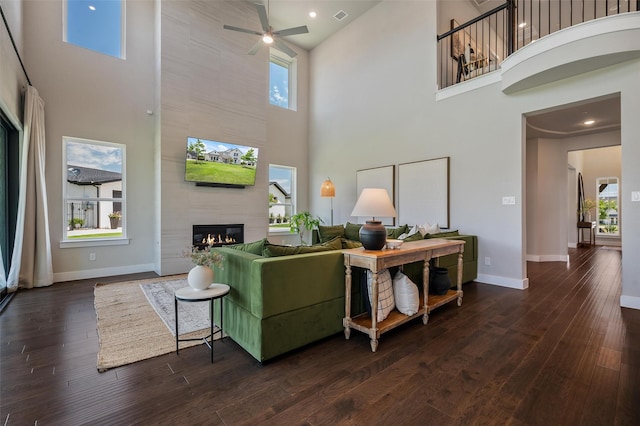 233 Kirkpatrick Ct, Argyle, TX 76226 - living room with a towering ceiling, a tile fireplace, ceiling fan, dark wood-style floors, and recessed lighting