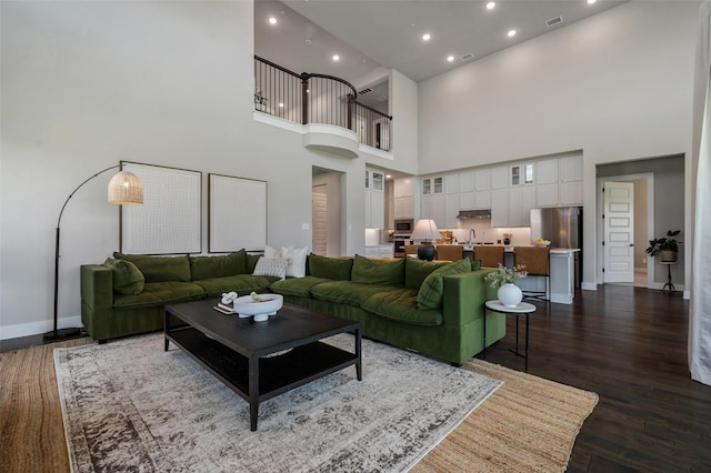 233 Kirkpatrick Ct, Argyle, TX 76226 - living area featuring a towering ceiling, dark wood finished floors, and recessed lighting