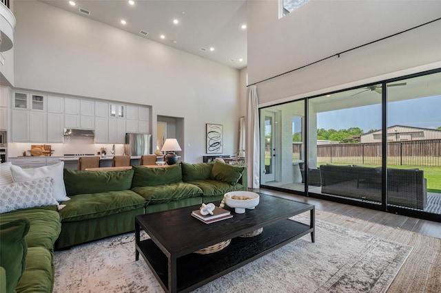233 Kirkpatrick Ct, Argyle, TX 76226 - living room with a high ceiling, plenty of natural light, recessed lighting, and light wood-type flooring