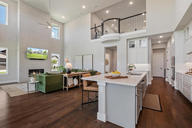 233 Kirkpatrick Ct, Argyle, TX 76226 - kitchen with a towering ceiling, stainless steel appliances, light countertops, an island with sink, and ceiling fan