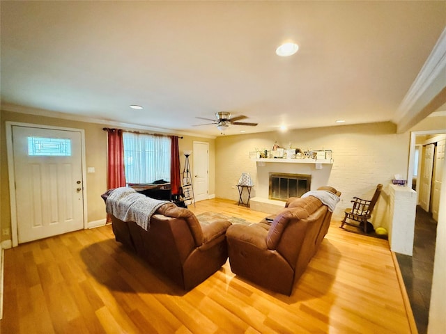 380 NE 32nd St, Paris, TX 75460 - living room with light wood finished floors, crown molding, a ceiling fan, a glass covered fireplace, and recessed lighting