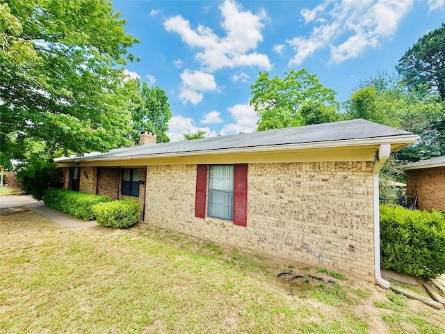 380 NE 32nd St, Paris, TX 75460 - view of property exterior with a chimney, brick siding, and a yard