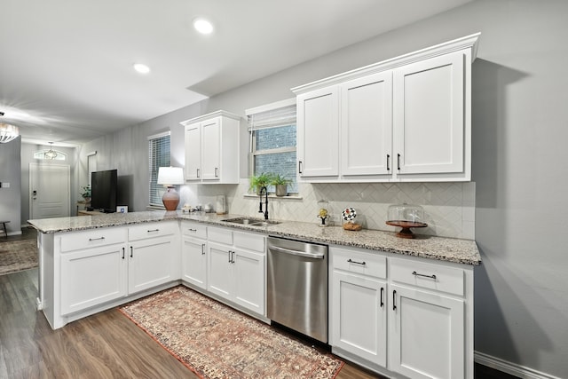 2136 Miramar Dr, Little Elm, TX 75068 - kitchen featuring stainless steel dishwasher, a peninsula, dark wood-type flooring, white cabinetry, and backsplash