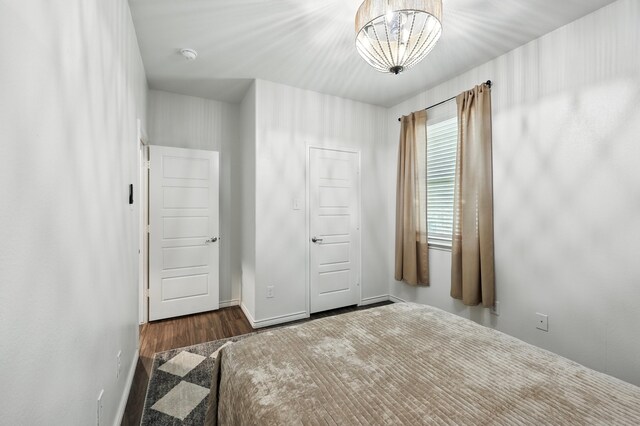 2136 Miramar Dr, Little Elm, TX 75068 - unfurnished bedroom featuring wood finished floors and a chandelier