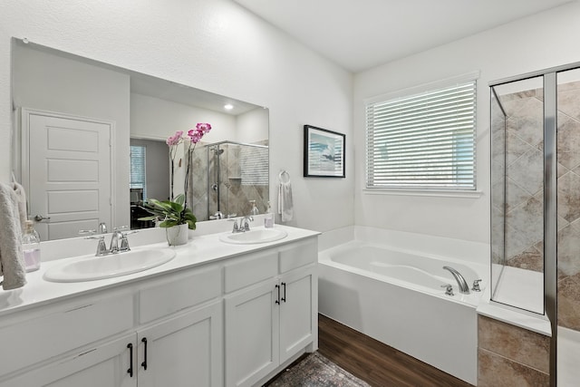 2136 Miramar Dr, Little Elm, TX 75068 - bathroom featuring a shower stall, a bath, double vanity, and wood finished floors