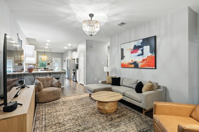2136 Miramar Dr, Little Elm, TX 75068 - living area featuring a chandelier, wood finished floors, and recessed lighting