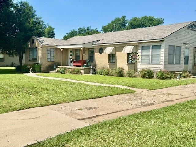 2025 16th St, Garland, TX 75041 - single story home featuring covered porch, a front lawn, and brick siding