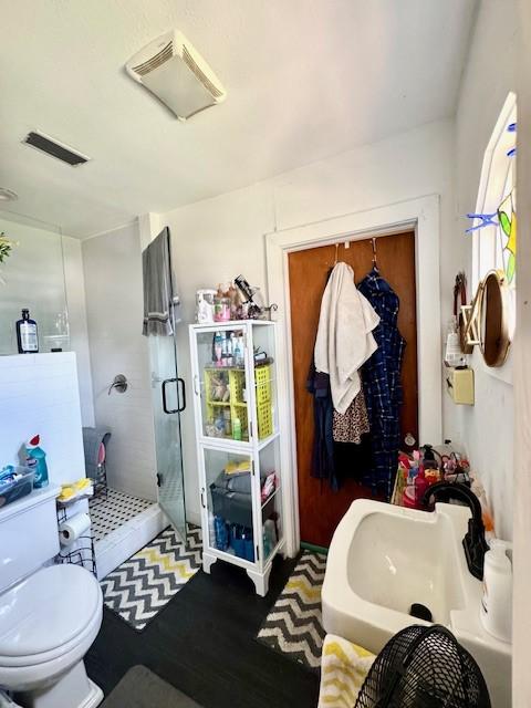 2025 16th St, Garland, TX 75041 - full bathroom featuring a stall shower and wood finished floors