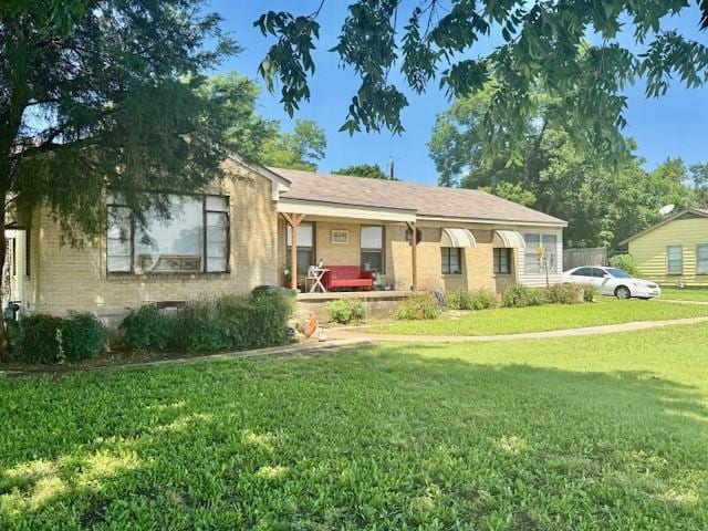 2025 16th St, Garland, TX 75041 - ranch-style home featuring a front lawn, brick siding, and covered porch