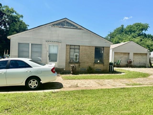 2025 16th St, Garland, TX 75041 - view of front of property featuring a front lawn, brick siding, a garage, and an outbuilding
