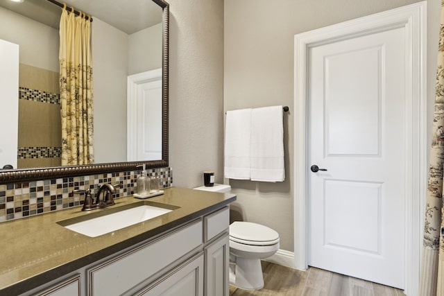 2824 Mastil Rd, Grand Prairie, TX 75054 - full bathroom featuring vanity, wood finished floors, a tile shower, and backsplash
