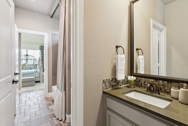 2824 Mastil Rd, Grand Prairie, TX 75054 - bathroom featuring vanity, stone tile flooring, decorative backsplash, and shower / bath combo with shower curtain