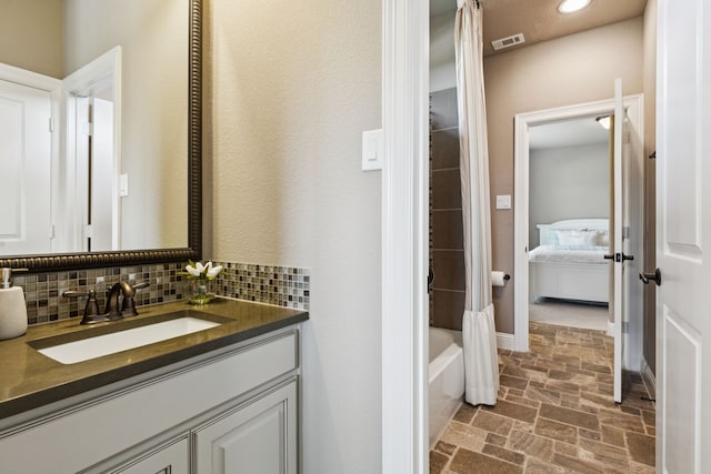2824 Mastil Rd, Grand Prairie, TX 75054 - ensuite bathroom with stone finish flooring, vanity, shower / tub combo with curtain, and tasteful backsplash