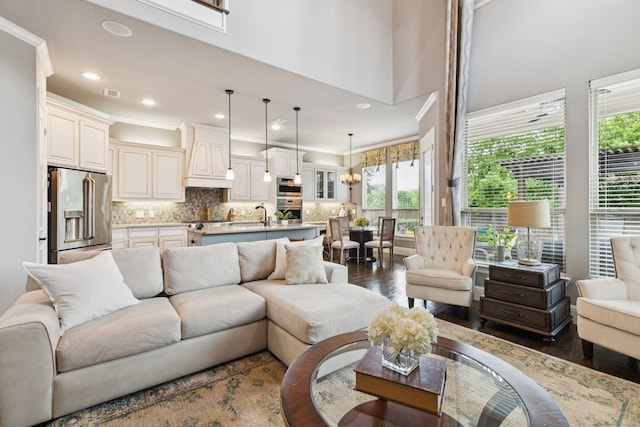 2824 Mastil Rd, Grand Prairie, TX 75054 - living room featuring dark wood-style flooring, healthy amount of natural light, recessed lighting, crown molding, and a chandelier