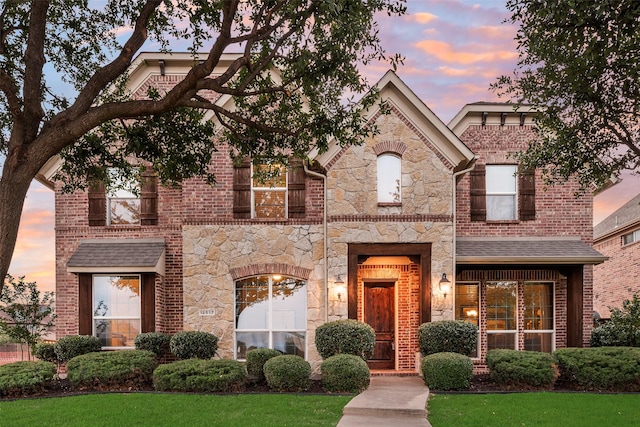 12517 Peace River Dr, Frisco, TX 75035 - view of front facade with stone siding, brick siding, and a yard