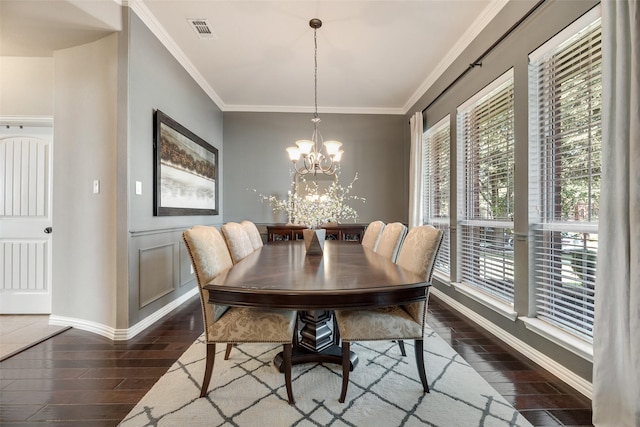 12517 Peace River Dr, Frisco, TX 75035 - dining space with dark wood-style floors, a chandelier, and crown molding