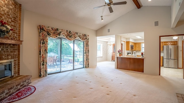3 Cimarron Dr, Trophy Club, TX 76262 - living room with a brick fireplace, beam ceiling, ceiling fan, light carpet, and high vaulted ceiling