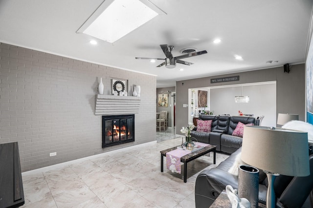 2008 Morningside Dr, Garland, TX 75041 - living area featuring ceiling fan, brick wall, a skylight, a brick fireplace, and recessed lighting