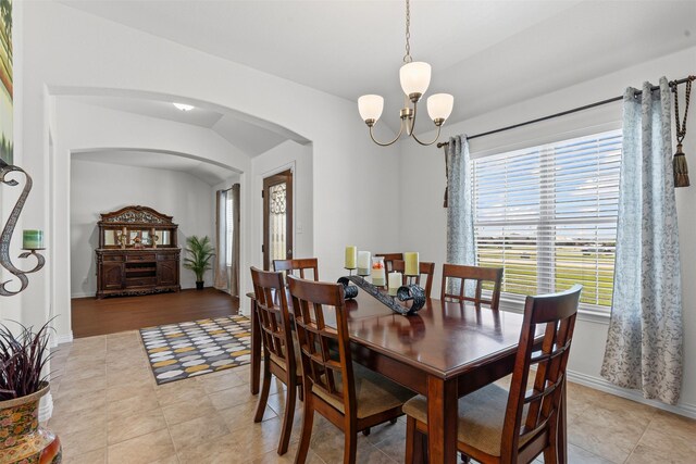 104 Knoll Ln, Decatur, TX 76234 - dining area with arched walkways, a chandelier, and light tile patterned flooring