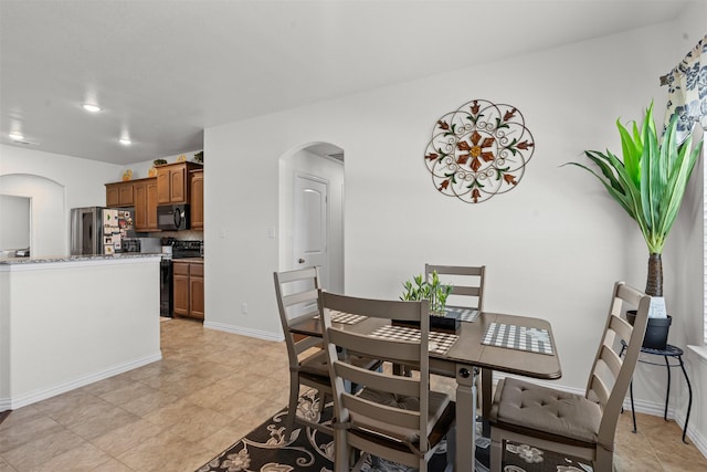 104 Knoll Ln, Decatur, TX 76234 - dining area featuring arched walkways and light tile patterned flooring
