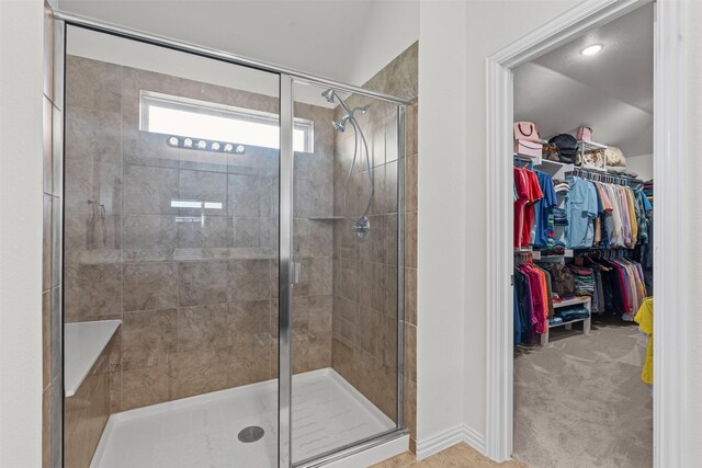 104 Knoll Ln, Decatur, TX 76234 - bathroom featuring a shower stall, a walk in closet, and lofted ceiling